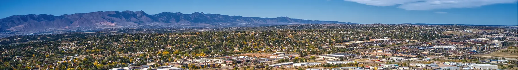 Panoramic view of a city with mountains in the background